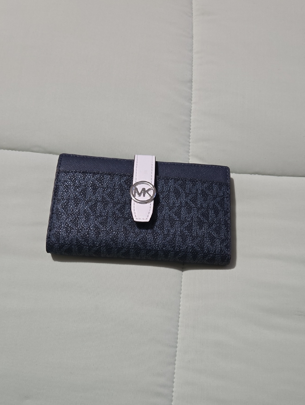 Michael Kors navy wallet with white strap and silver MK logo